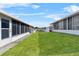 Expansive lawn area between properties, enclosed back patios enhance outdoor living at 392 Winter Ridge Blvd # 105, Winter Haven, FL 33881
