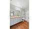 Bright bathroom featuring a vanity, well-lit mirror, and a walk-in shower, offering a refreshing space at 392 Winter Ridge Blvd # 105, Winter Haven, FL 33881