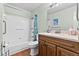 Traditional bathroom with neutral wall paint, a wooden vanity and combined tub and shower at 392 Winter Ridge Blvd # 105, Winter Haven, FL 33881