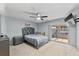 Serene bedroom with soft blue walls, a comfortable bed, and natural light, ideal for relaxation at 392 Winter Ridge Blvd # 105, Winter Haven, FL 33881