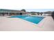 Well-maintained community pool with surrounding lounge chairs and a safety fence at 392 Winter Ridge Blvd # 105, Winter Haven, FL 33881