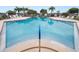 Beautiful community pool with various lounge chairs and easy access to the water via stairs at 392 Winter Ridge Blvd # 105, Winter Haven, FL 33881