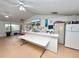 Reception area in the community room featuring a fridge and community information board at 392 Winter Ridge Blvd # 105, Winter Haven, FL 33881