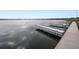 Scenic lake view featuring a wooden dock with several boat slips ready for use at 392 Winter Ridge Blvd # 105, Winter Haven, FL 33881