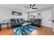 Inviting living room with dark sofas, modern ceiling fan, and bright natural light at 392 Winter Ridge Blvd # 105, Winter Haven, FL 33881