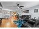 Open-concept living space with hardwood flooring, adjacent dining and kitchen areas at 392 Winter Ridge Blvd # 105, Winter Haven, FL 33881