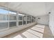 Enclosed patio area features tile floors, multiple sliding windows and white walls at 392 Winter Ridge Blvd # 105, Winter Haven, FL 33881