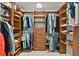 Spacious walk-in closet features custom built-in shelving, drawers and ample storage for clothes and shoes at 392 Winter Ridge Blvd # 105, Winter Haven, FL 33881