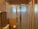 Bathroom featuring glass shower doors, toilet, and chrome hardware at 5062 El Destino Dr, Leesburg, FL 34748