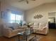 Living room featuring neutral walls, ceiling fan, and lots of natural light at 5062 El Destino Dr, Leesburg, FL 34748