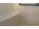 All-white shower with tiled walls, bench and chrome grab bar at 5062 El Destino Dr, Leesburg, FL 34748