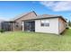 Large backyard with grassy area and screened porch at 516 Pamplona Pl, Davenport, FL 33837