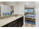 Bathroom with double vanity and view of bedroom at 516 Pamplona Pl, Davenport, FL 33837