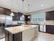 Modern kitchen with granite island and stainless steel appliances at 516 Pamplona Pl, Davenport, FL 33837