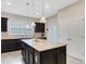 Modern kitchen with granite island and stainless steel appliances at 516 Pamplona Pl, Davenport, FL 33837