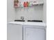 Laundry room with Whirlpool washer and dryer, and shelving at 516 Pamplona Pl, Davenport, FL 33837