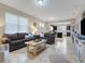 Open concept living room with view of kitchen and access to other rooms at 516 Pamplona Pl, Davenport, FL 33837