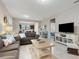Open living room with a view into kitchen and other rooms at 516 Pamplona Pl, Davenport, FL 33837