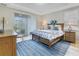 Main bedroom with king-size bed and access to backyard patio at 516 Pamplona Pl, Davenport, FL 33837