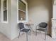 Cozy patio with wicker chairs and small table at 516 Pamplona Pl, Davenport, FL 33837