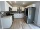 Bright kitchen features stainless steel appliances, white cabinets, quartz countertops, and mosaic backsplash at 101 Gerry Dr, Altamonte Springs, FL 32714