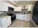 Modern kitchen with stainless steel appliances, white cabinetry, quartz countertops, and accent tile backsplash at 101 Gerry Dr, Altamonte Springs, FL 32714
