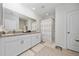 Bright bathroom featuring double vanity and shower with curtain at 1687 Park Side Ave, Kissimmee, FL 34744