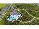 Aerial view showcases community pool with palm trees, cabanas, landscaping, and winding walking trails at 1687 Park Side Ave, Kissimmee, FL 34744