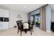 Dining area with a round table and sliding glass doors leading to the backyard at 1687 Park Side Ave, Kissimmee, FL 34744