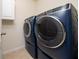 Laundry room showcasing a modern washer and dryer set with stainless steel accents at 1687 Park Side Ave, Kissimmee, FL 34744