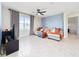 Inviting living room featuring tile flooring, a comfortable sofa, and a large window at 1687 Park Side Ave, Kissimmee, FL 34744