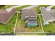 An aerial view showing the backyard with screened-in pool and fencing surrounding the property at 18035 Cadence St, Orlando, FL 32820