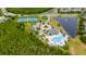Community aerial view featuring a pool, tennis courts, pond, and surrounding landscape in the neighborhood at 18035 Cadence St, Orlando, FL 32820