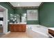 Bathroom with large bathtub, window with blinds, and spacious vanity at 18035 Cadence St, Orlando, FL 32820
