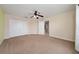 A serene bedroom features neutral carpet and a ceiling fan with views into another room through the doorway at 18035 Cadence St, Orlando, FL 32820