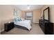 Relaxing bedroom showcases a comfortable bed, soft carpet, and dresser with stylish mirror above it at 18035 Cadence St, Orlando, FL 32820