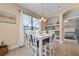 Dining area showcases a white table with seating for six and a window that filters in natural light at 18035 Cadence St, Orlando, FL 32820