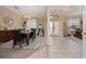 The dining room offers tile flooring, a chandelier, a mirror, and plenty of natural light from nearby windows at 18035 Cadence St, Orlando, FL 32820