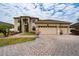 Beautiful two-story home featuring a three-car garage, landscaped yard, and a charming front entrance at 18035 Cadence St, Orlando, FL 32820