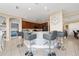 Kitchen boasts an island with barstool seating, dark cabinets, and modern appliances, creating a functional space at 18035 Cadence St, Orlando, FL 32820