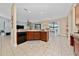 Open-concept kitchen shows modern appliances, a breakfast bar, and seamless connectivity to the living and dining areas at 18035 Cadence St, Orlando, FL 32820
