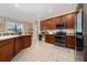 Functional kitchen features wooden cabinets, stainless steel appliances, and a convenient work area, perfect for cooking at 18035 Cadence St, Orlando, FL 32820
