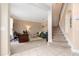 Inviting living room featuring neutral colors, a staircase, and a view into the adjacent home office space at 18035 Cadence St, Orlando, FL 32820
