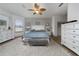 The main bedroom is bright with natural light, featuring a large bed, ceiling fan, and plush decor at 18035 Cadence St, Orlando, FL 32820