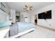 Relaxing main bedroom featuring a plush bed, ceiling fan, neutral tones and a large TV, inviting a peaceful retreat at 18035 Cadence St, Orlando, FL 32820