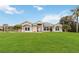 Inviting single-story home featuring a lush front lawn, elegant windows, and a welcoming entrance at 1960 Jan Lan Blvd, St Cloud, FL 34772