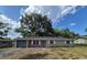 Lovely single-story home featuring gray garage door, brick accents, and a well-maintained front lawn at 6025 Se 119Th Pl, Belleview, FL 34420