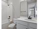 Clean bathroom with shower-tub combo, white tile surround, and modern fixtures at 1488 August Gray Dr, Kissimmee, FL 34744
