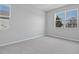 Neutral bedroom with soft carpet flooring and view of the neighborhood through a large window at 1488 August Gray Dr, Kissimmee, FL 34744