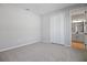 Comfortable carpeted bedroom features closet and adjoining bathroom at 1488 August Gray Dr, Kissimmee, FL 34744